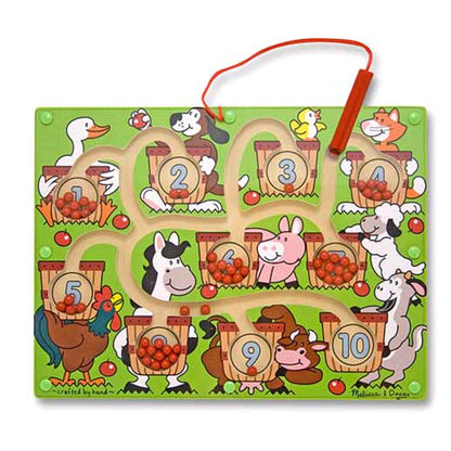Magnetic wand number maze with green board featuring numbered baskets 1-10, farm animals, and apples, with red magnetic wand attached