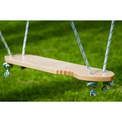 Wooden swing seat with rope handles against green grass background