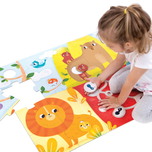 Modeled by a child, colorful floor puzzle featuring animals including a lion, bear, bird, and fish with matching pairs on yellow, blue, and red sections