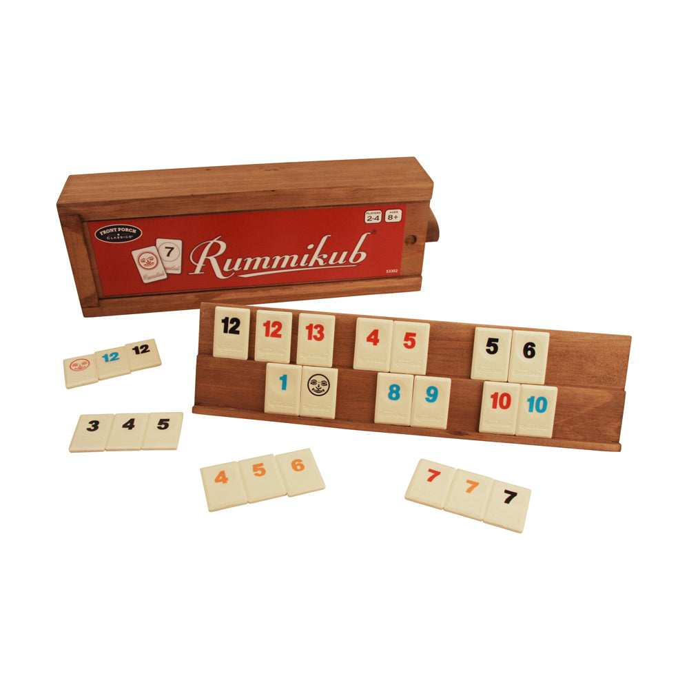 Rummikub Classic game with wooden storage box, showing numbered tiles arranged on wooden racks and loose tiles on plain background