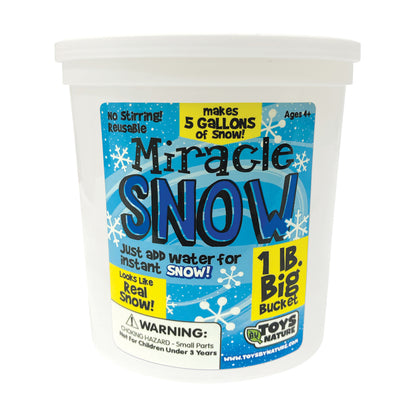 Miracle Snow instant snow kit in white 1lb bucket with blue and yellow label showing snowflakes, text reads 'makes 5 gallons of snow' and 'just add water for in