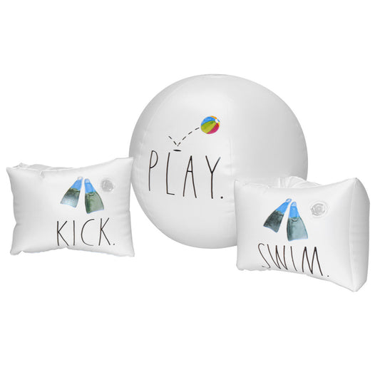 White inflatable swim wings with 'KICK' text and colorful fish graphics, paired with white beach ball reading 'PLAY' and rainbow ball graphic, on plain backgrou