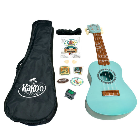 Kakoo Ukulele Starter Kit contents displayed: seafoam green soprano ukulele with wooden fretboard, black carrying case with Kakoo logo, black shoulder strap, tu