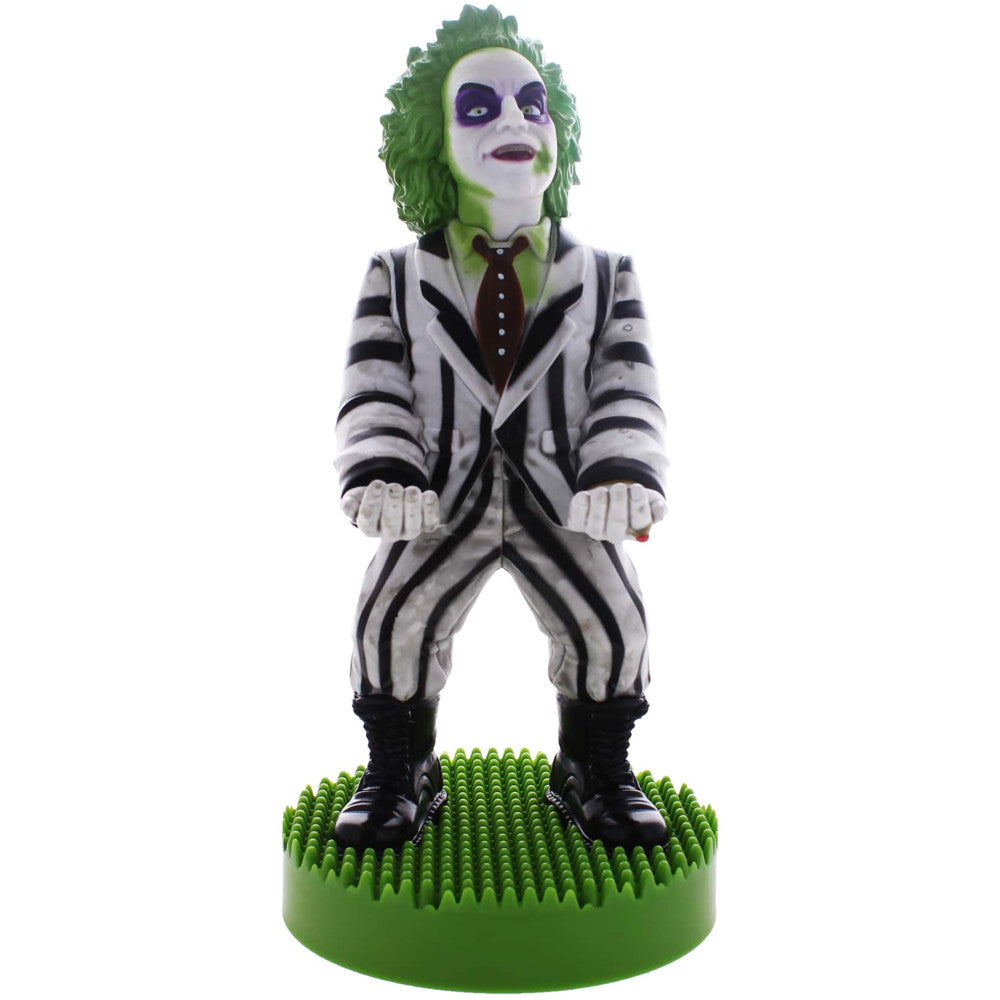 Beetlejuice action figure with green hair, white and black striped suit, purple eye makeup, standing on green spiky base