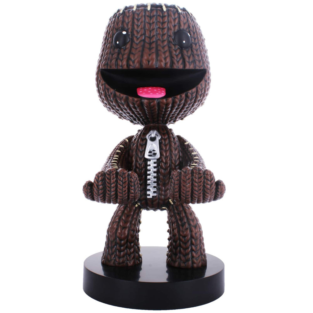 Brown knitted character figure with round head, black eyes, pink tongue, and white zipper down chest, standing on black base