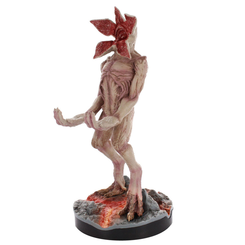 Demogorgon collectible figure from Stranger Things, pale pink creature with muscular body and red flower-shaped head detail, standing on base with glowing red l