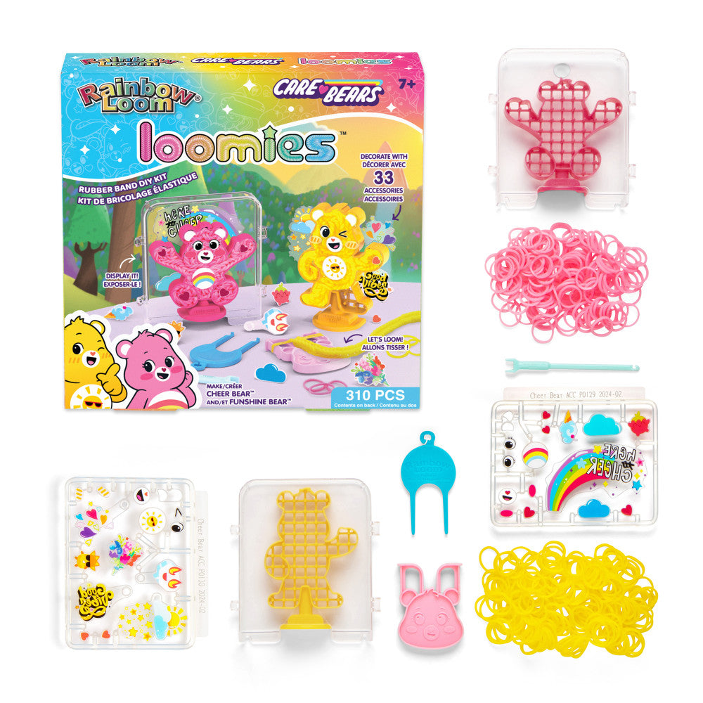 Rainbow Loom Care Bears Loomies kit contents including pink and yellow perler beads, plastic loom boards shaped like Cheer Bear and Funshine Bear, tool, and 33