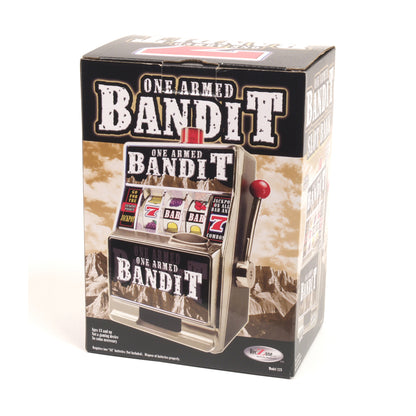One Armed Bandit miniature slot machine bank with red lever, displayed in packaging showing Western landscape background