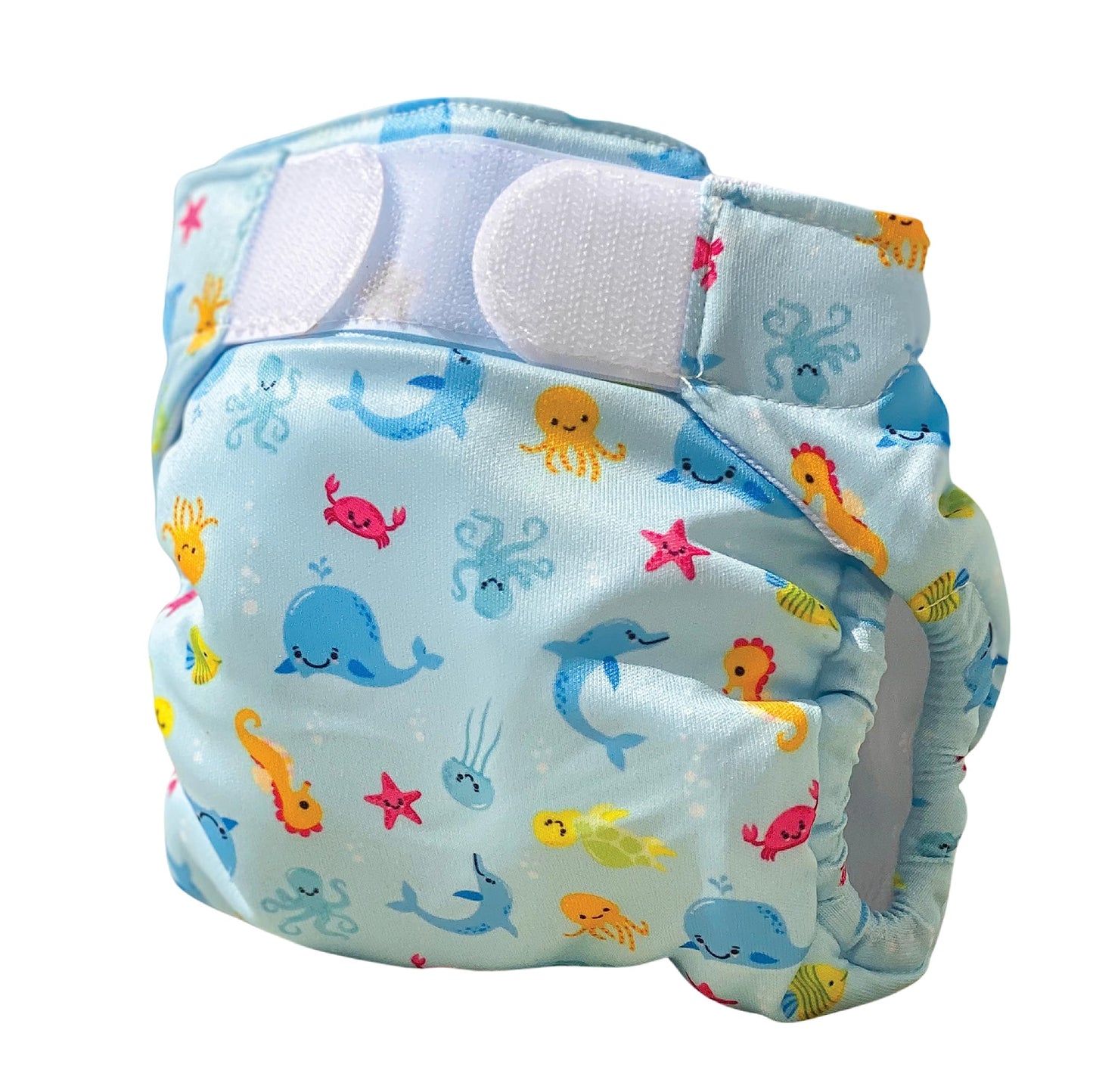 Blue swim nappy with colorful sea creatures including whales, jellyfish, starfish, seahorses, and fish, with white waterproof panels and blue trim