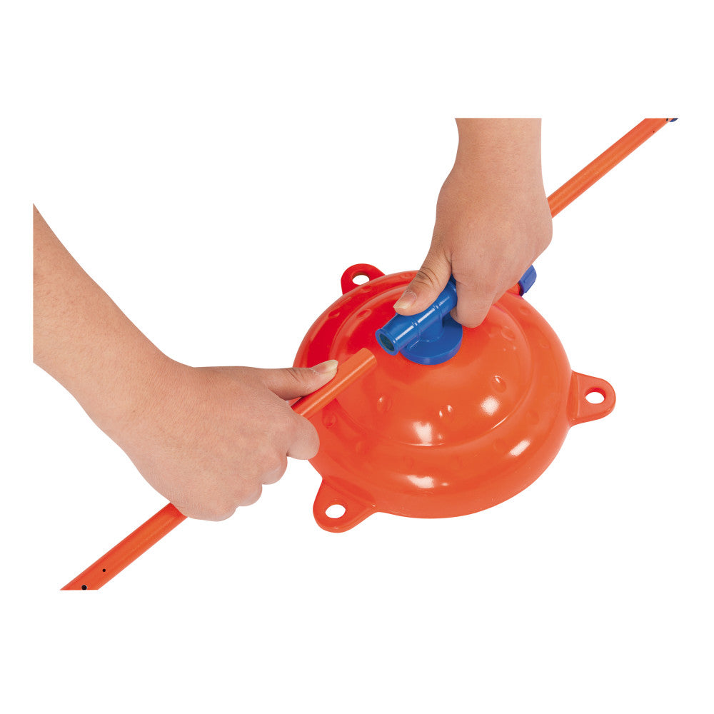 Red rotating water sprinkler with blue handle, modeled by a child holding orange poles on white background
