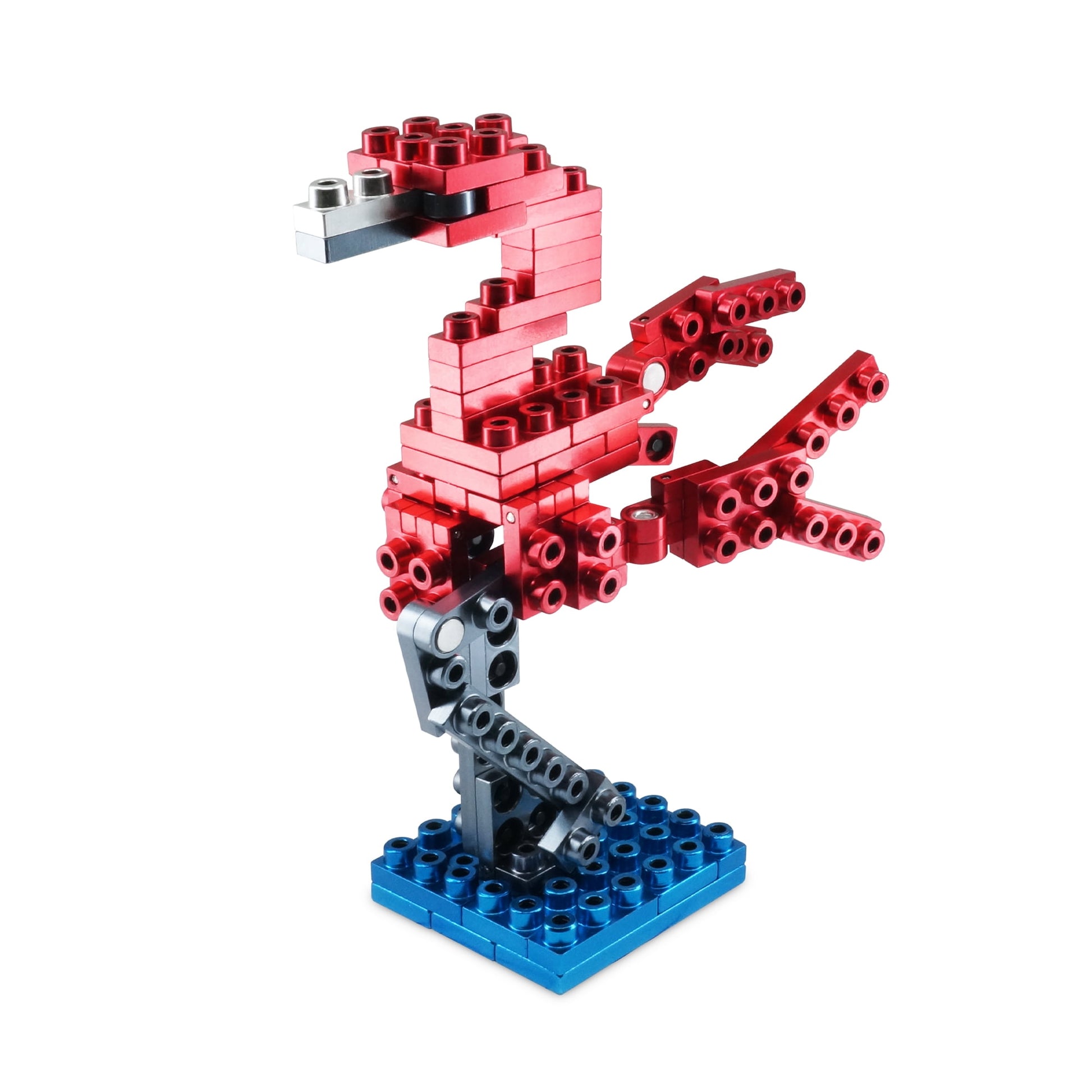 Red and blue metal alloy building blocks assembled into a flamingo figure with articulated wings and legs on a blue base