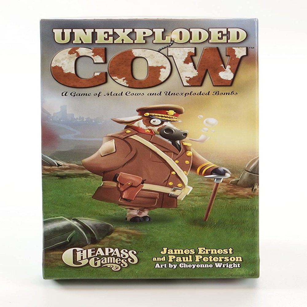 Unexploded Cow Deluxe Card Game box featuring an illustrated cartoon cow in military uniform standing in a battlefield landscape