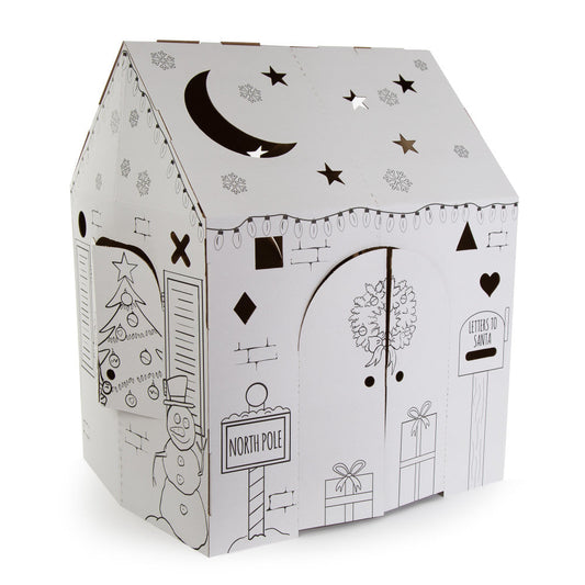 White cardboard playhouse with black line drawings of Christmas scenes including snowman, North Pole sign, presents, tree, moon and stars on roof, and letters t