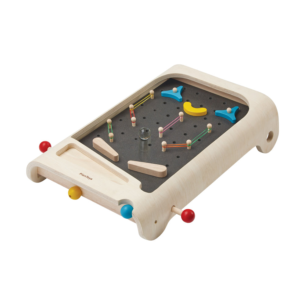Wooden pinball game board with natural finish, dark gray playing surface, wooden pegs, colored ball launchers on sides, and yellow banana-shaped and blue flippe