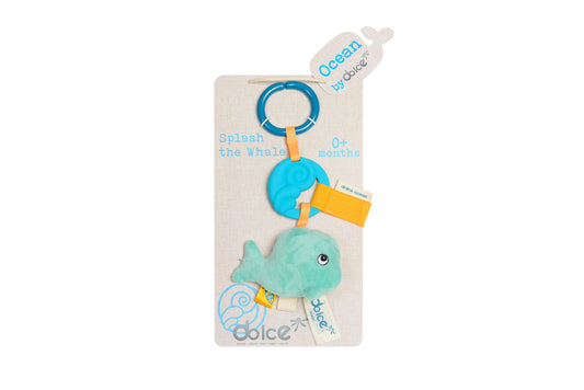 Dolce Splash the Whale teether toy with blue ring, yellow textured fabric tag, and mint green plush whale body on packaging card