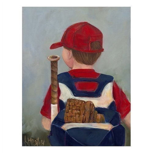 Child from behind wearing red baseball cap and navy blue baseball uniform with mitt, holding wooden baseball bat