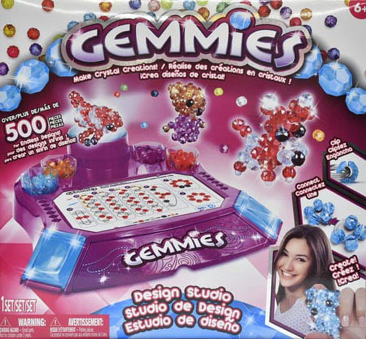 Gemmies Crystal Creations Design Studio Kit with purple base, crystal beads in multiple colors, design templates, and sample creations displayed
