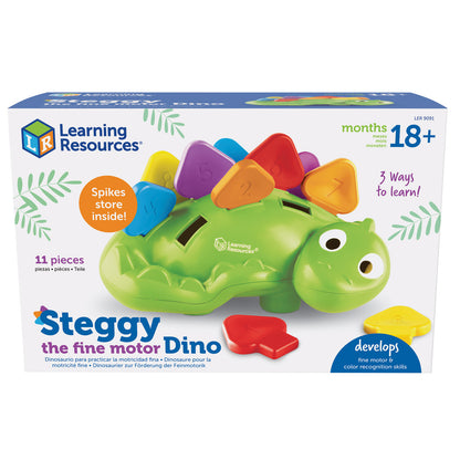 Green dinosaur toy with colorful spike pieces on back, featuring large eyes and storage slots, with red and yellow spike pieces shown separately