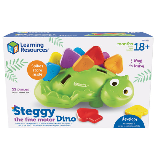 Green dinosaur toy with colorful spike pieces on back, featuring large eyes and storage slots, with red and yellow spike pieces shown separately