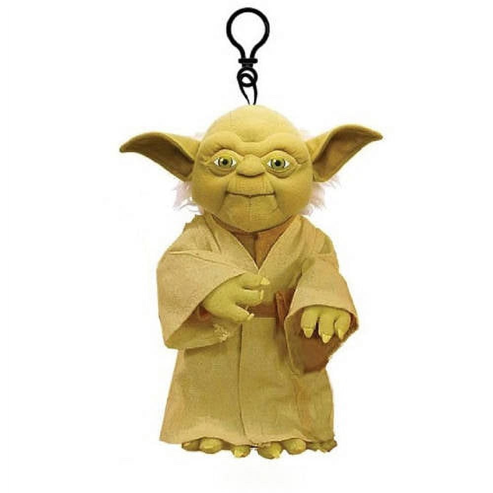 Yellow plush Yoda figure with pointed ears, wrinkled face, and tan robe, featuring a black clip hook at top