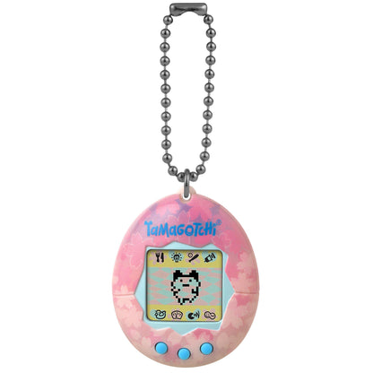 Pink Tamagotchi Original Sakura Edition digital pet with cherry blossom pattern, pixel character display, game icons, three blue buttons, and metal ball chain k