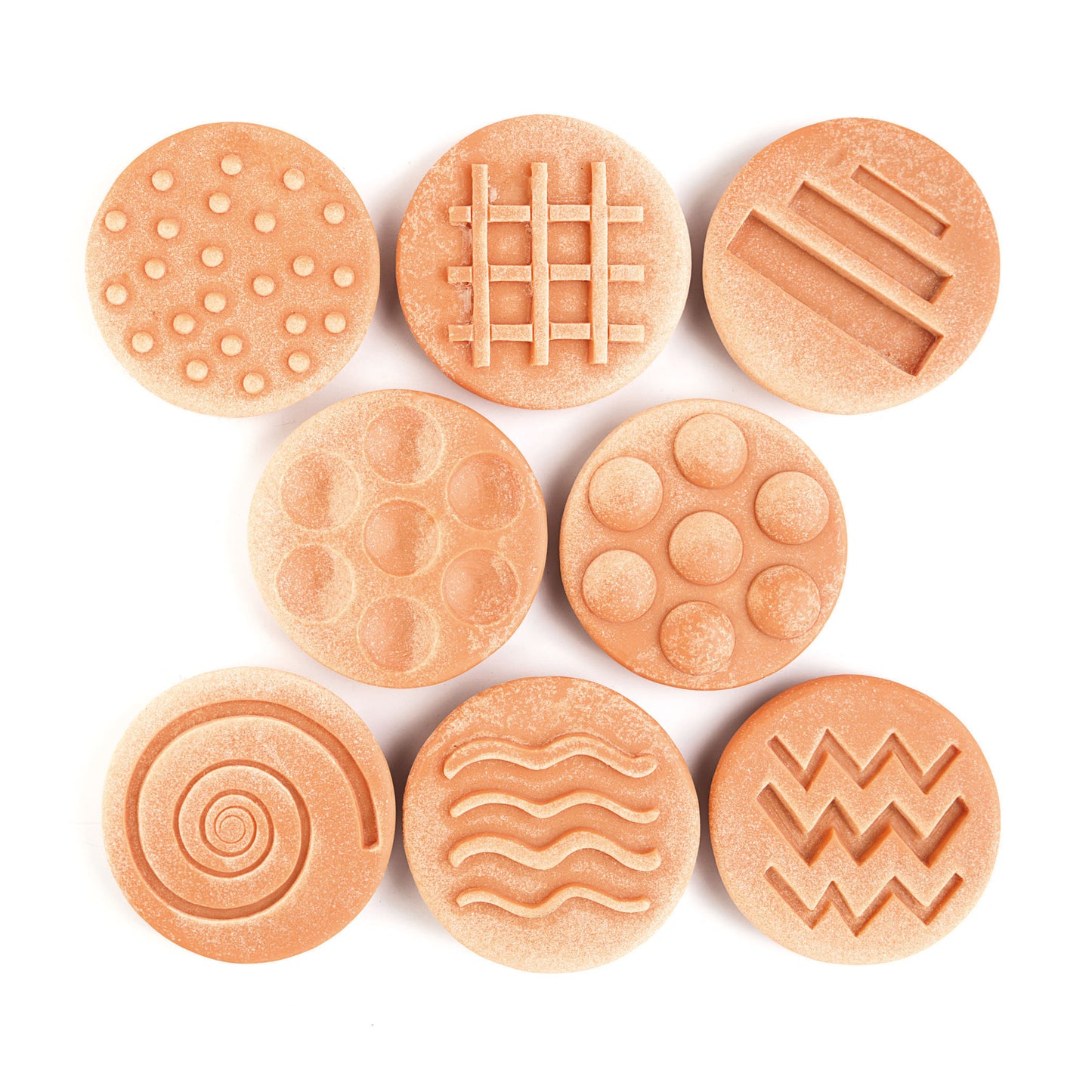 Eight terracotta-colored textured stones with embossed patterns including dots, grid, lines, circles, spiral, and wavy designs