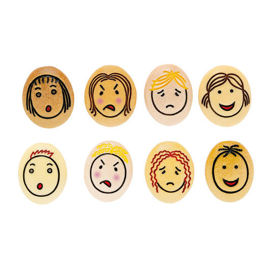 Eight wooden emotion stones with hand-drawn faces showing different feelings: surprised, sad, angry, happy, shocked, upset, crying, and smiling