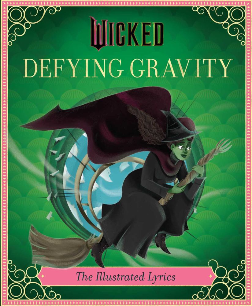 Wicked Defying Gravity The Illustrated Lyrics book cover featuring a green-skinned witch on a broomstick against a green background with decorative gold and pin