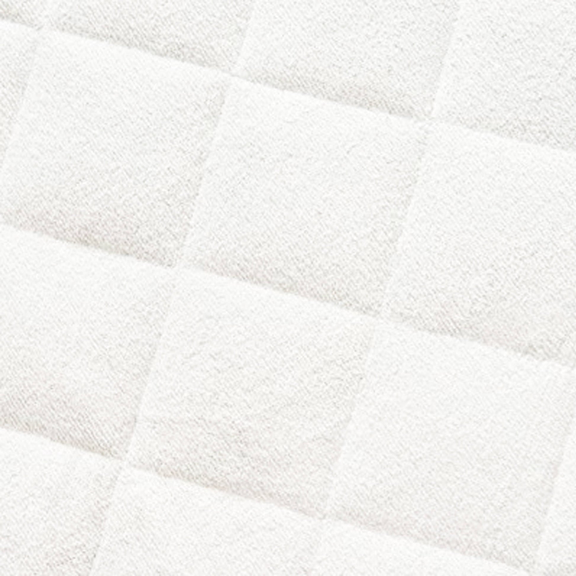 Close-up of quilted bamboo mattress protector showing white padded fabric with diagonal quilting pattern