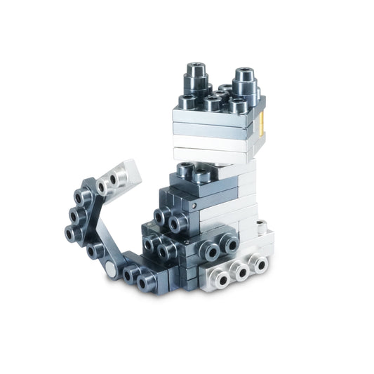 Stacked modular building blocks in white, light blue, dark blue, and black with silver metallic connector pieces, forming an abstract sculptural structure