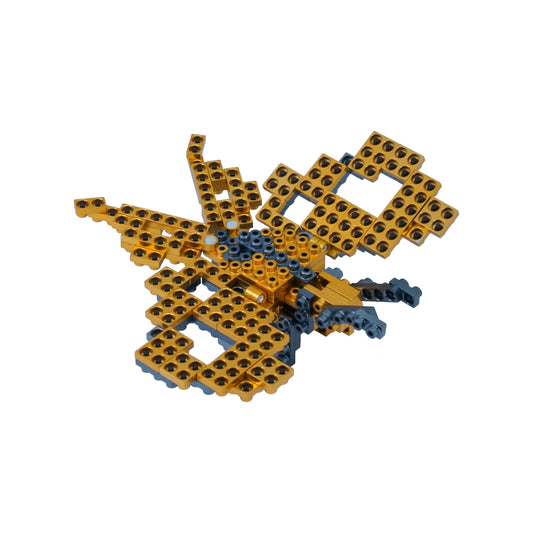 Gold and blue modular building blocks assembled into a three-dimensional insect form with wings and geometric structure