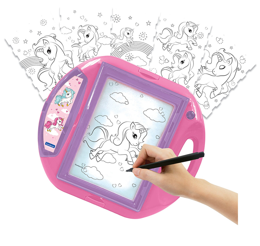 Pink and purple drawing projector with unicorn design, modeled by a child holding a stylus over the illuminated screen showing unicorn outlines to color