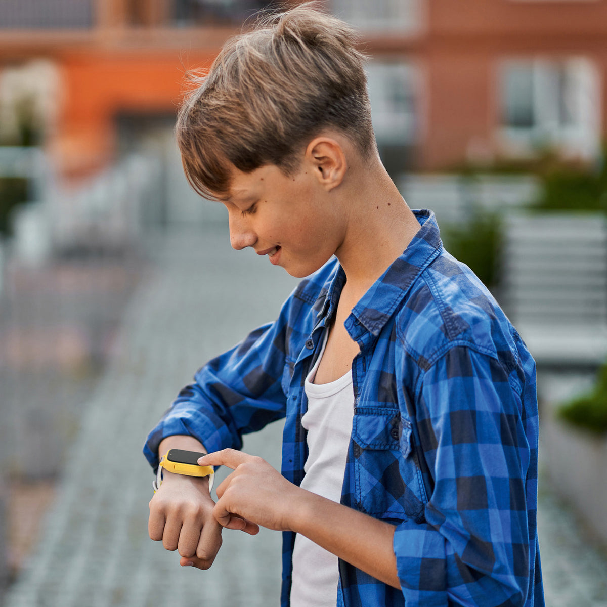 Boy wearing Batman Digital Watch with camera in blue plaid shirt