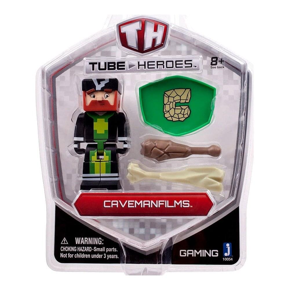 Tube Heroes Caveman Films action figure with red hair and black outfit, includes green shield accessory and brown and cream bone accessories, packaged in clear