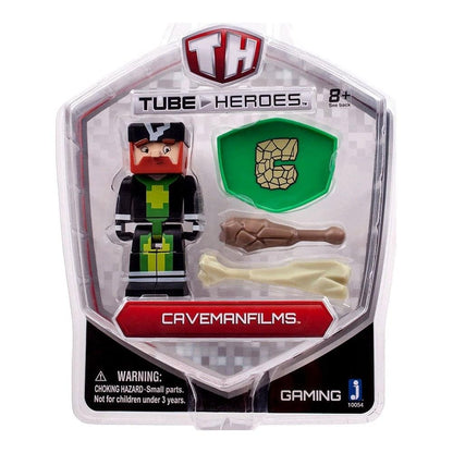 Tube Heroes Caveman Films action figure with red hair and black outfit, includes green shield accessory and brown and cream bone accessories, packaged in clear