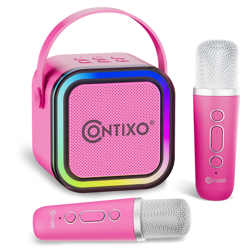 Pink Contixo karaoke machine with LED-lit speaker, carrying handle, and two wireless microphones with mesh heads