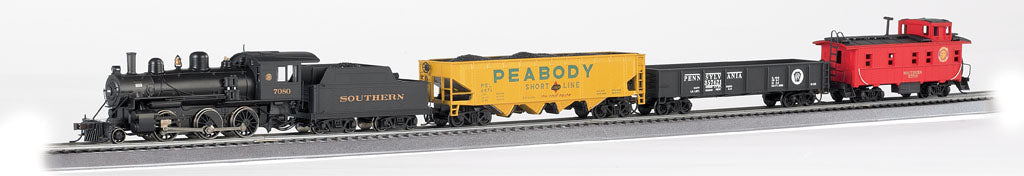 HO scale model train set with black steam locomotive, Southern tender car, yellow Peabody hopper car, black freight car, and red caboose on gray track