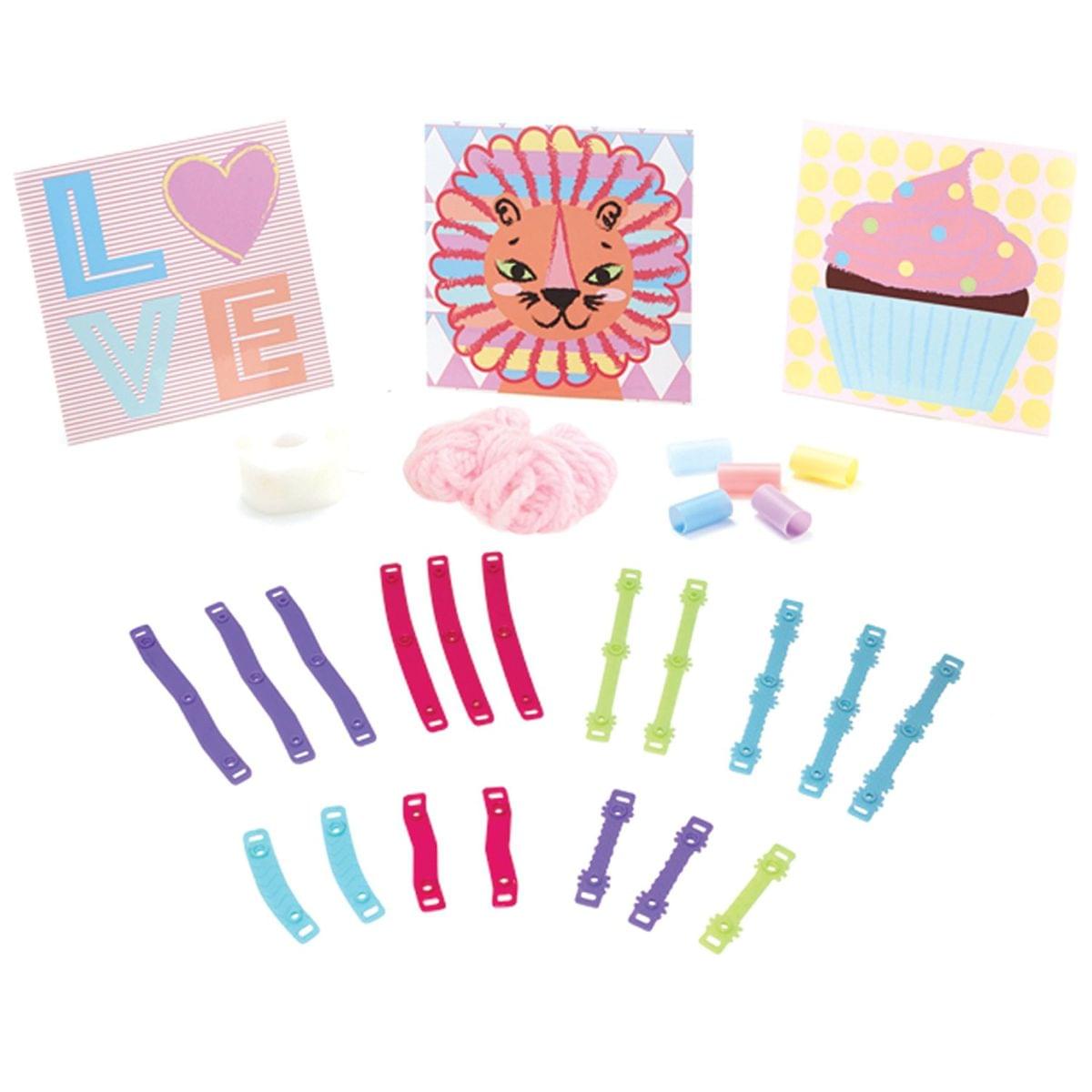 Pom Pom Wow Snap & Decorate Set contents including three canvas boards with LOVE heart, lion face, and cupcake designs, pink pom poms, colorful snap clips in pu