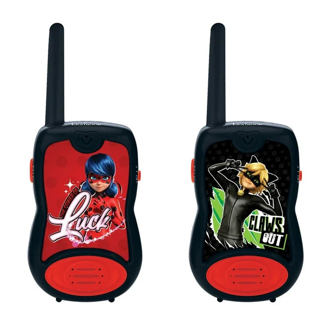 Pair of Miraculous Ladybug walkie talkies with black casing, red accents, and extendable antennas. Left unit features Ladybug character on red background; right