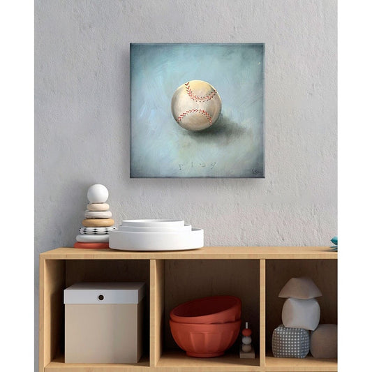 Canvas wall art featuring a painted baseball with red stitching on a soft blue-green background, displayed above a wooden storage unit