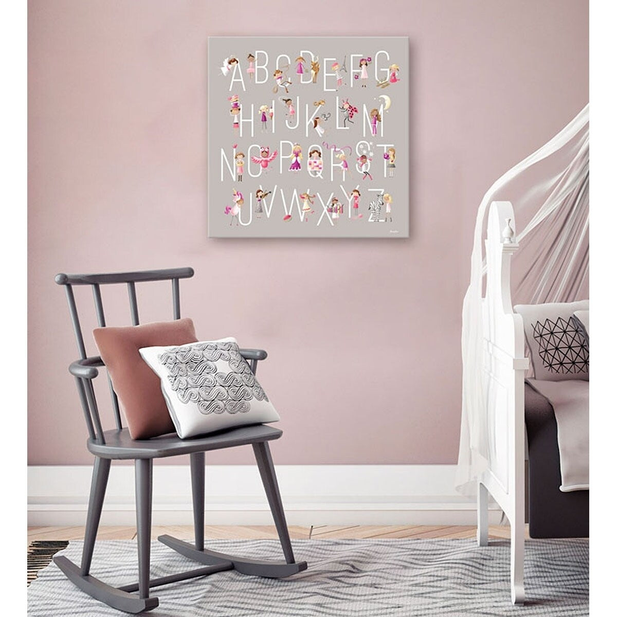 Hand-stretched canvas art displaying alphabet letters A-Z with illustrated children in various poses and activities filling each letter, hung on pink bedroom wa