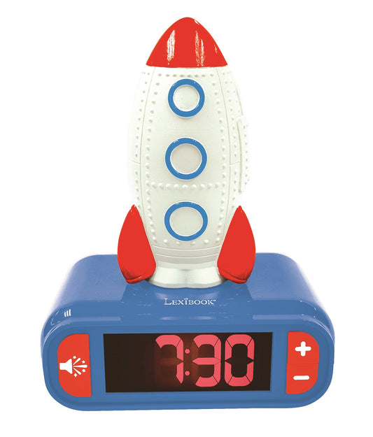 Red and white rocket-shaped alarm clock with blue base, digital display showing 3:30, and three blue porthole windows on the rocket body