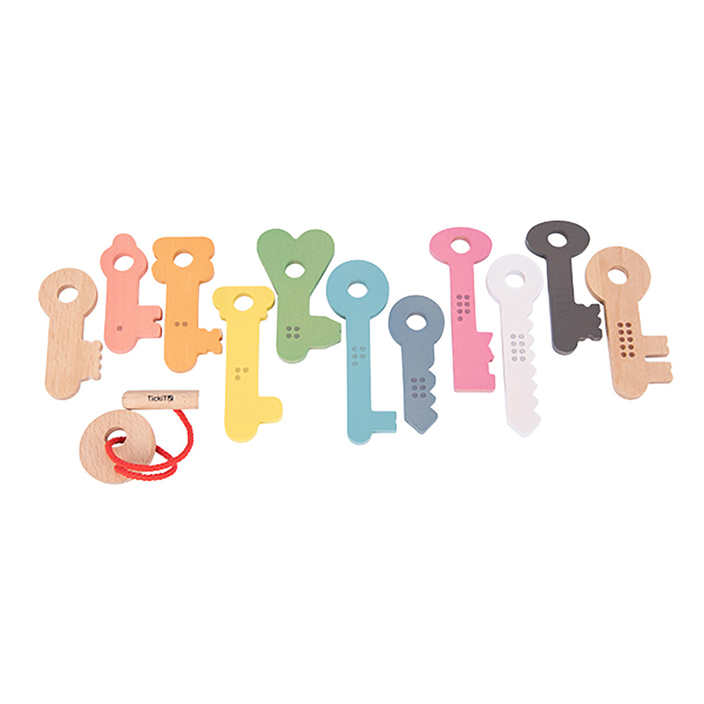 Set of 11 colorful wooden keys in natural wood, coral, orange, yellow, green, blue, slate, pink, white, and tan with textured details and holes for stringing