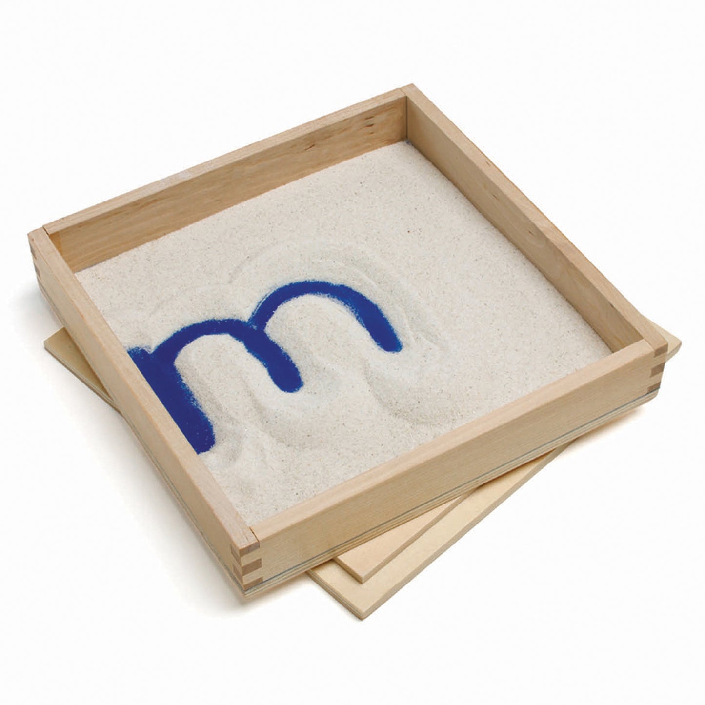 Wooden sand tray with white sand and blue letter formation guide shaped like curved lines for tactile writing practice