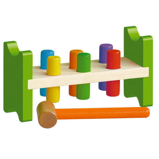 Wooden pound-a-peg bench toy with green frame, cream platform, colorful pegs in blue, yellow, orange, green, purple, and red, and wooden mallet with orange hand