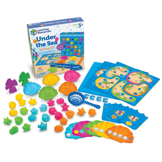 Learning Resources Under the Sea Sorting Set with colorful sea creature figurines, shell-shaped sorting trays, blue activity cards, and net tool on white backgr