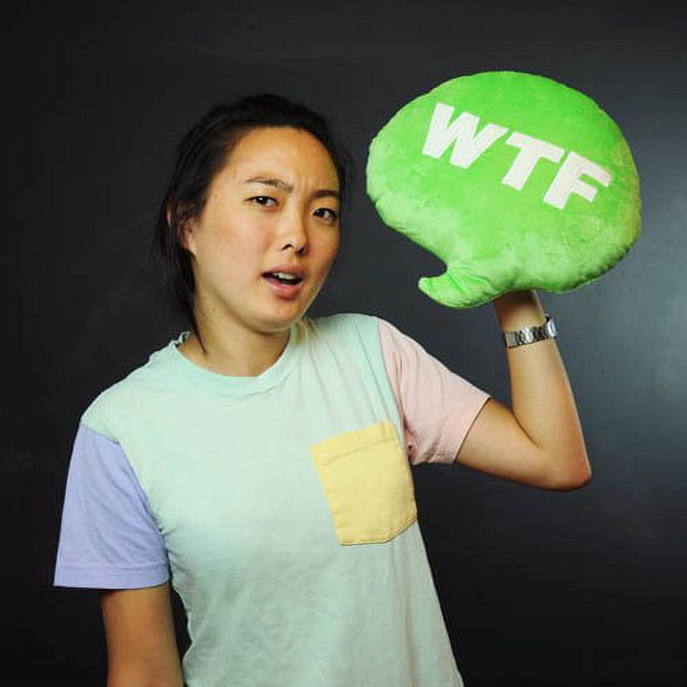 Bright green speech bubble pillow printed with 'WTF' text, modeled by a person holding it against their shoulder