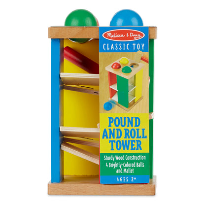 Melissa & Doug Pound and Roll Tower wooden toy with blue and green sides, yellow interior, four colored balls on top, and mallet for hammering