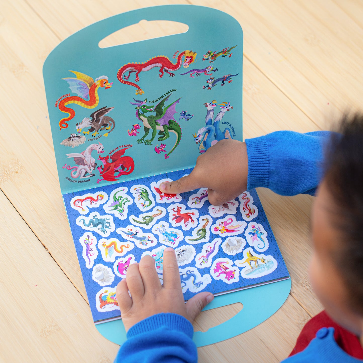 eeBoo Shiny Dragon Sticker Book with colorful dragon stickers on blue background