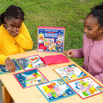 United States Geography Bingo game with colorful game boards and cards on wooden table